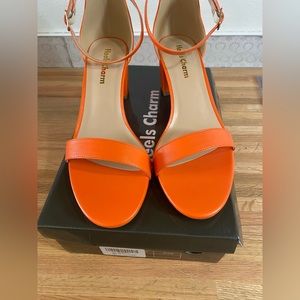 Beautiful orange heels size 8.5. NEVER WORN. Heels charm